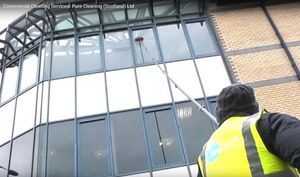 cleaning office windows with deionized water and water fed pole. 